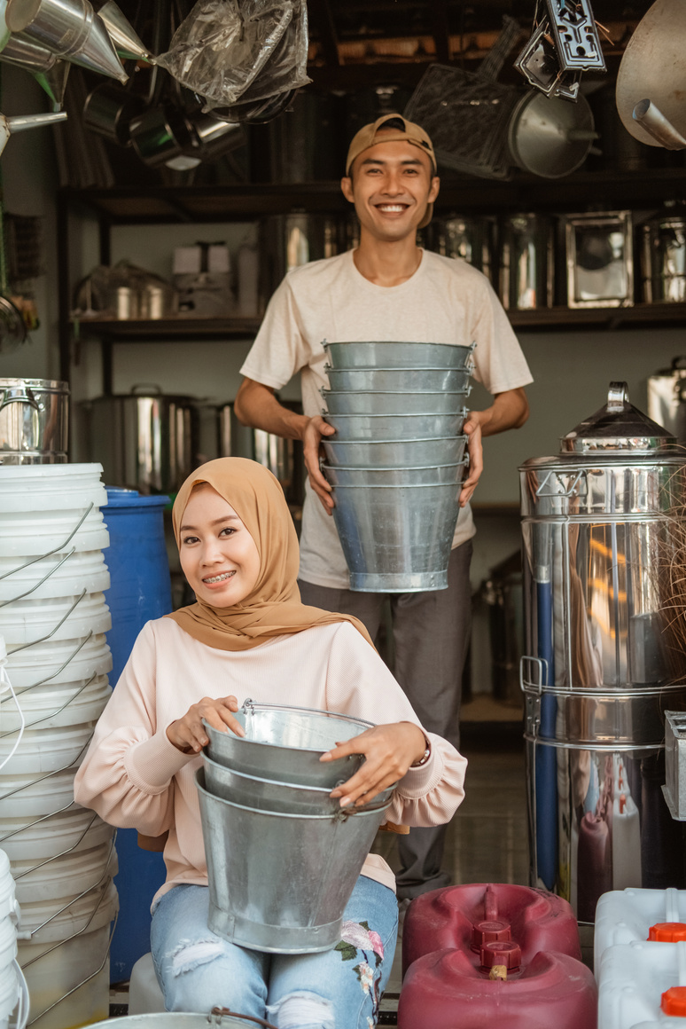 Asian Couple Seller Smiling While Holding the Bucket
